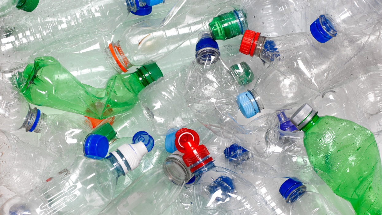 discarded used water bottles in recycling bin.  The lids can be recycled as well if reattached to the water bottle