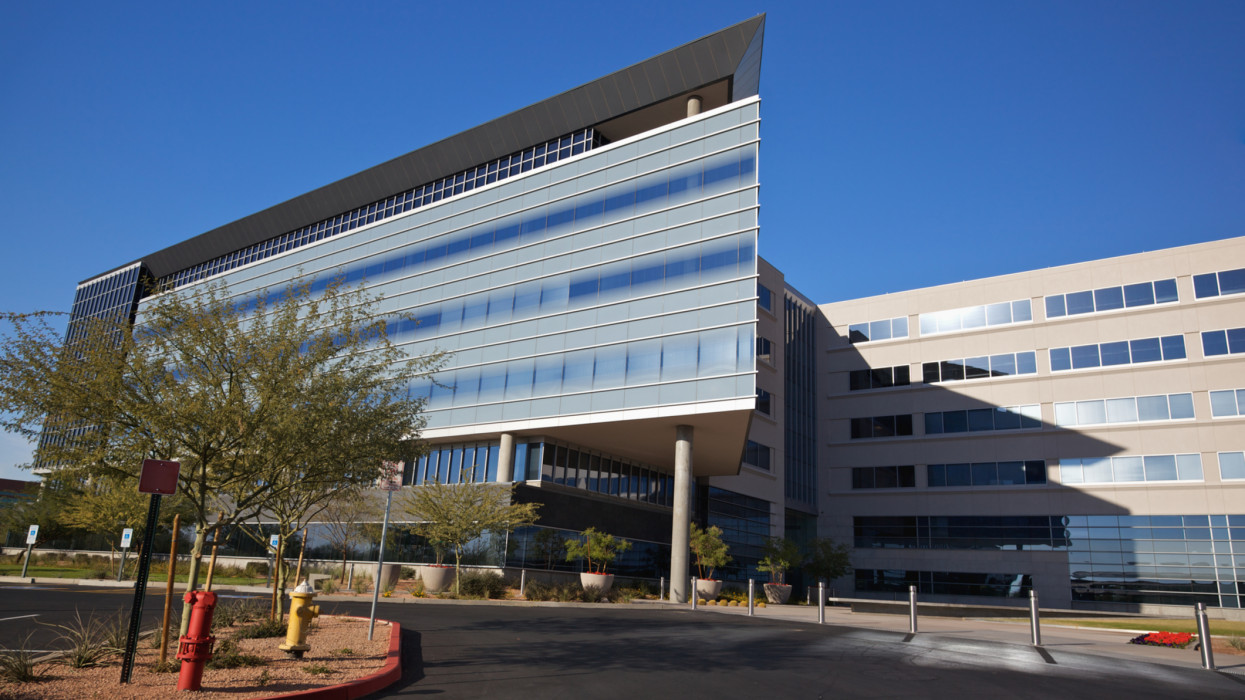 Scottsdale Arizona angular business building modern 20th century style on a clear day with palo verde trees set on a bright blue clear sky background