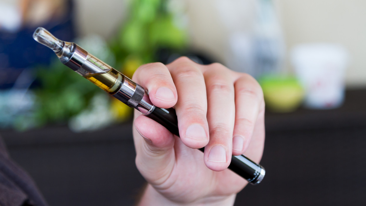 Man hand holding electronic cigarette.