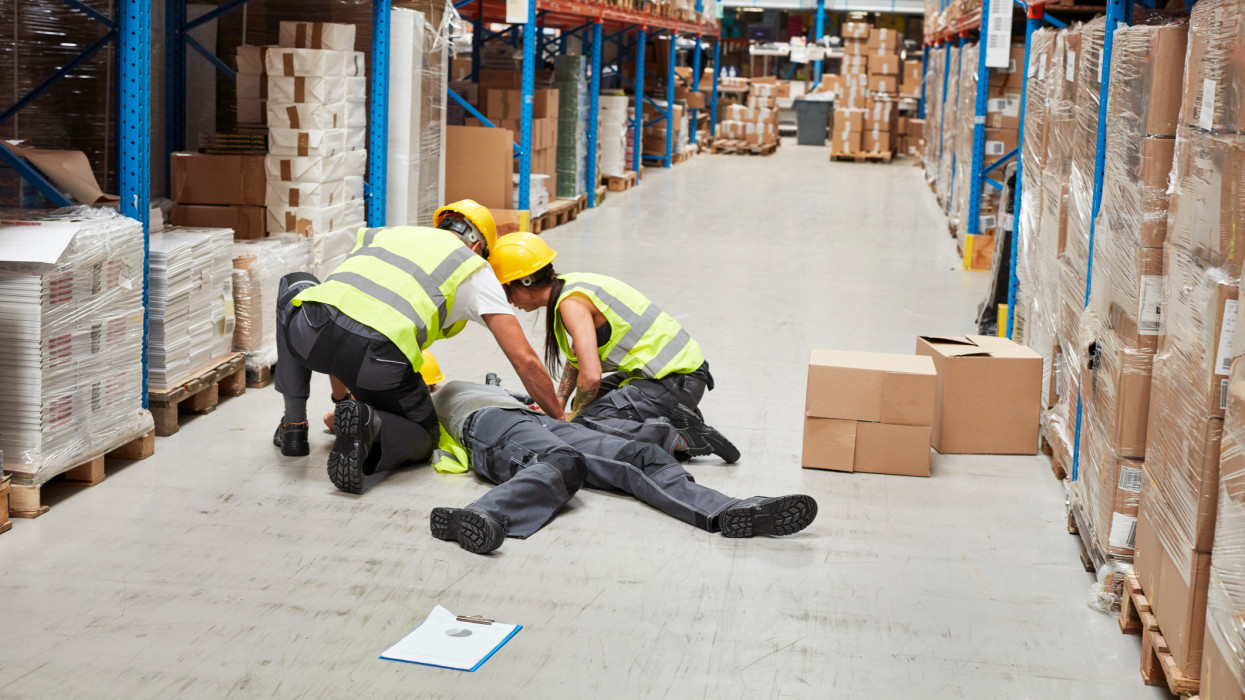 Woman lying on the floor. Accident in warehouse