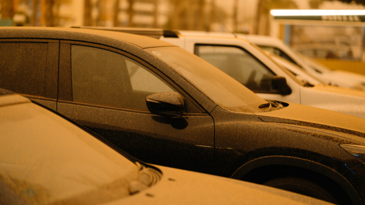 Dirty cars by calima. Dust storm from Sahara desert in Torrox Costa, Andalusia