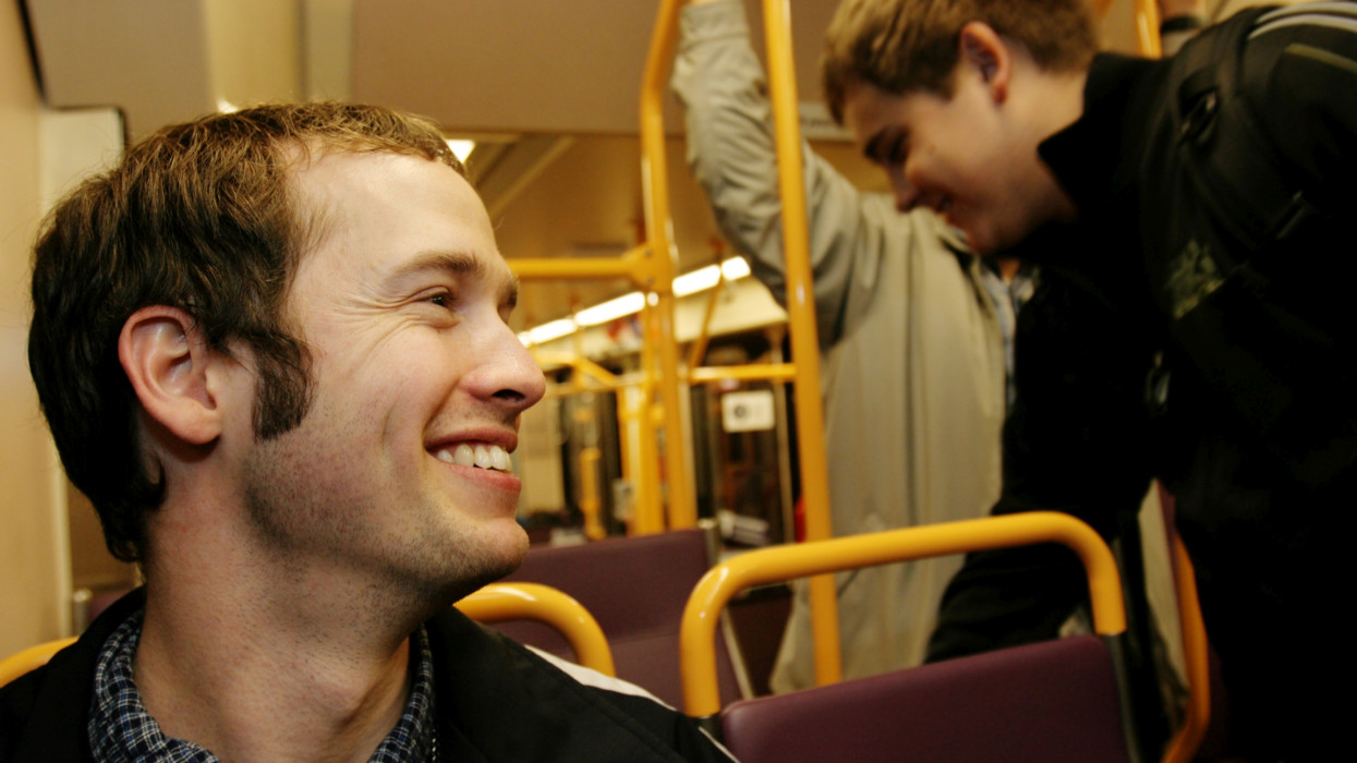 young men on public transportation