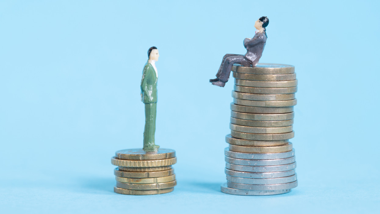 The coins and the two people (figurines) represent the increase in the cost of living.