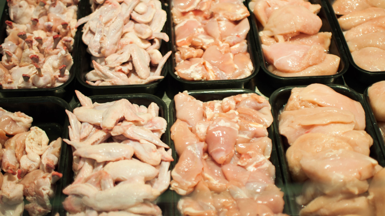 A close-up view of raw chicken parts in the supermarket