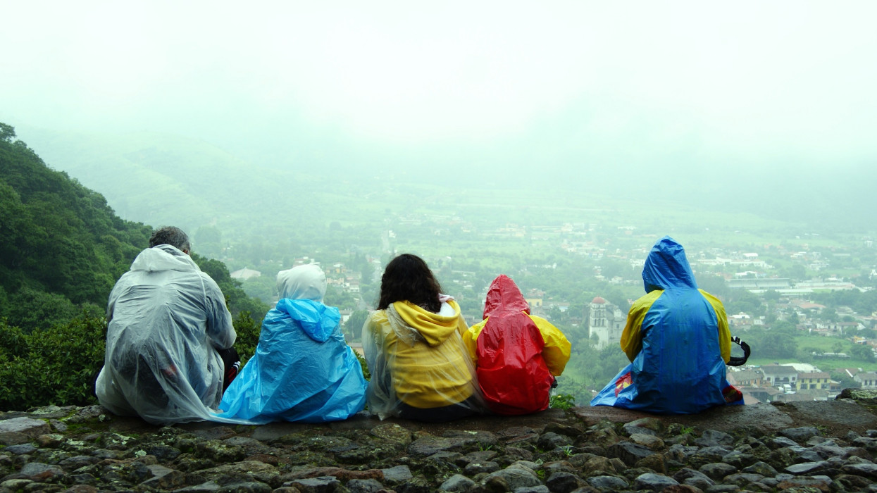 At top of hill of Malinalco, Mexico family takes time to eat and enjoy view of city.