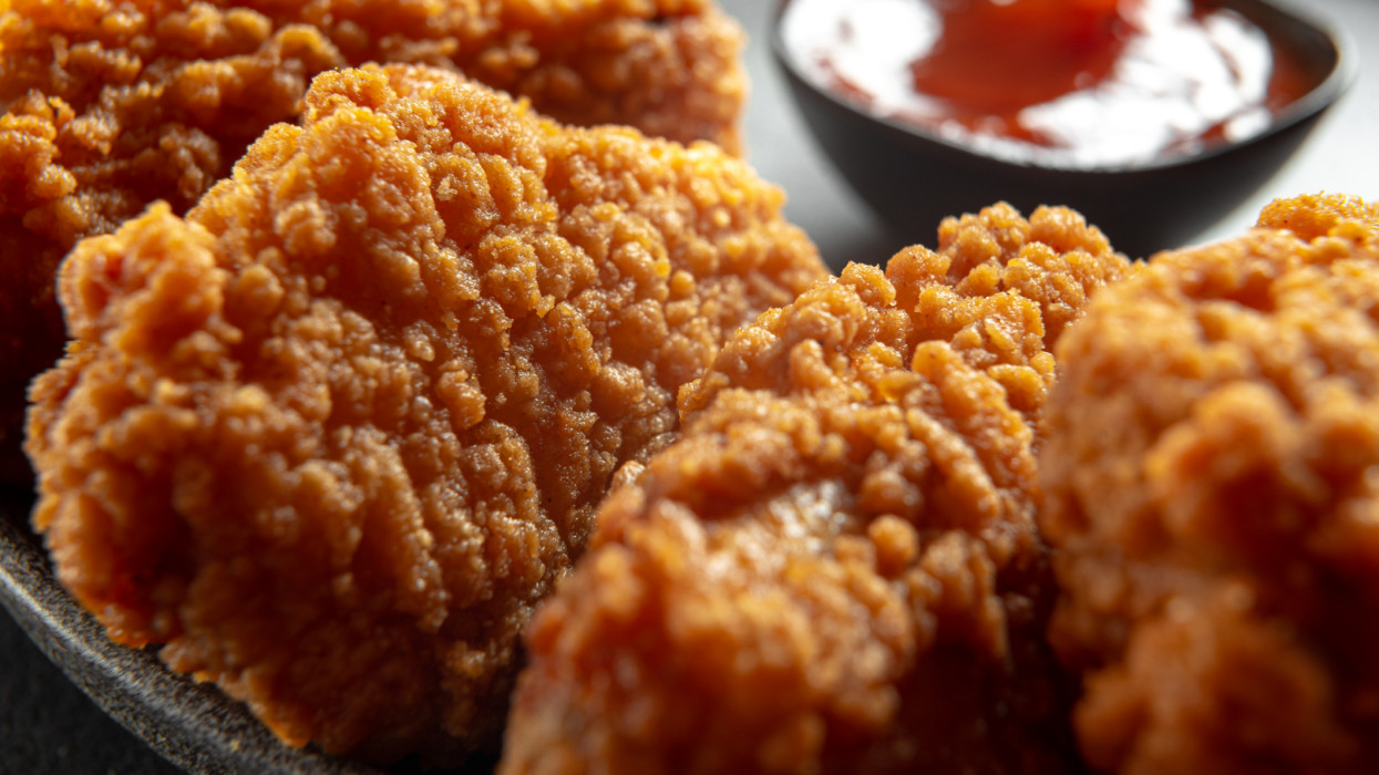 Fried chicken fillet on a dark background. Fried chicken wings as in KFC at home close-up