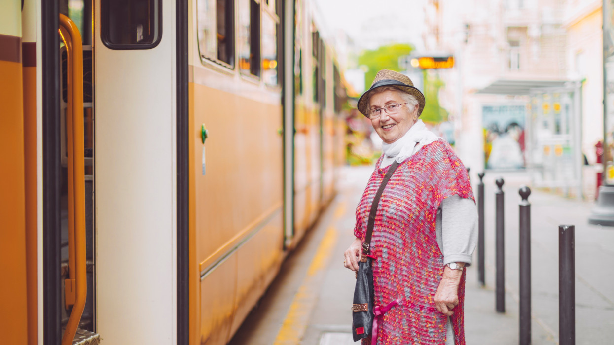 Beautiful senior woman is enjoying herself tram budapest