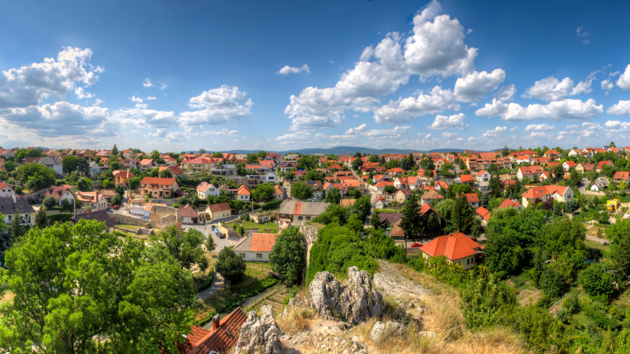 Panoramic view over a housing estate with detached houses on the outskirts of Veszprem, a town near Lake Balaton in Hungary, in fine weather and clear clouds