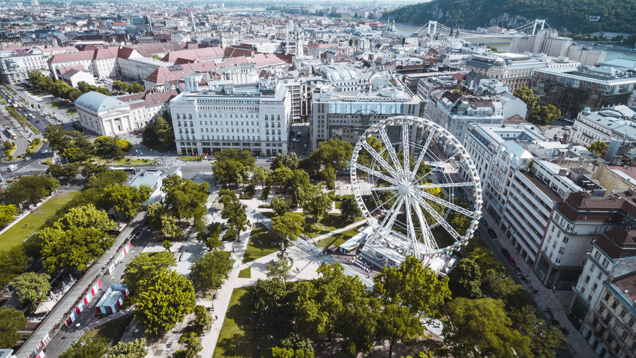 Drone panoramic skyline view of DeÃ¡k Ferenc square with ferris wheel.