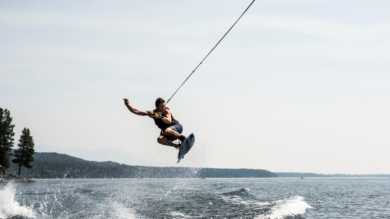 A man wake boarding on Whitefish lake