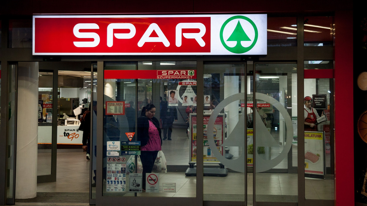Logo of Spar on one of their supermarkets of Hungary in Budapest, at night. Spar is an international group of franchises of retailers and wholesalers who work together in partnership under the Spar brand
