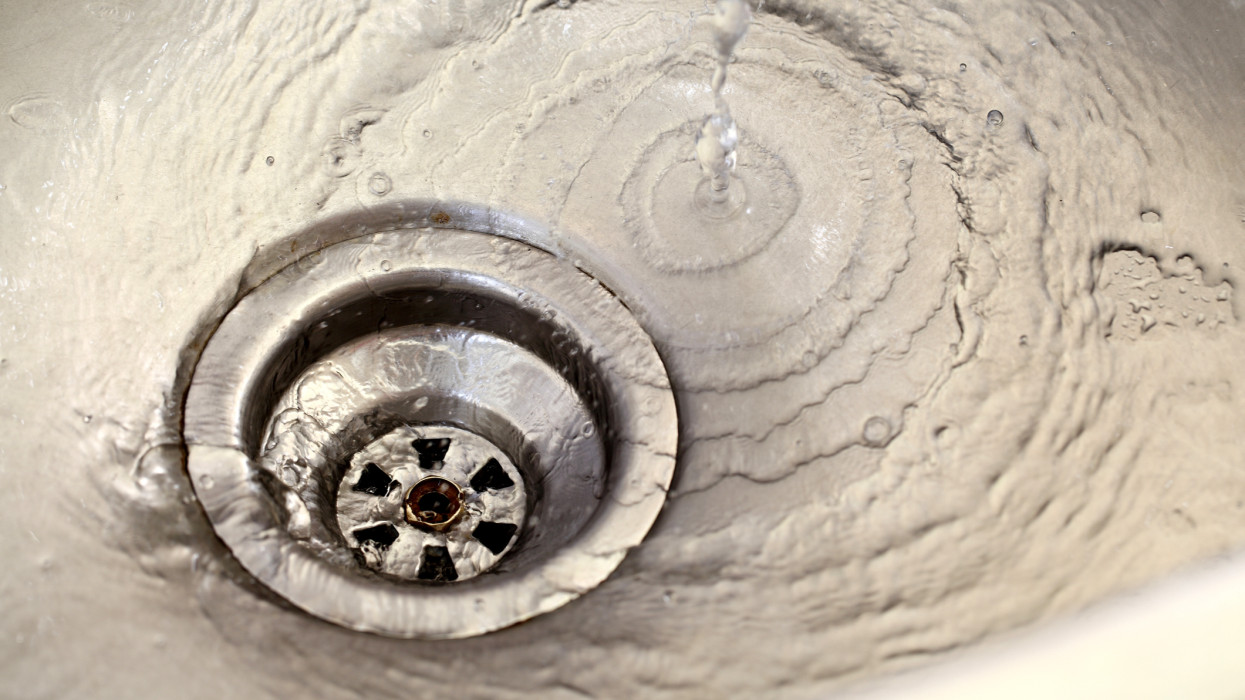 Closeup view of kitchen sink with flowing water