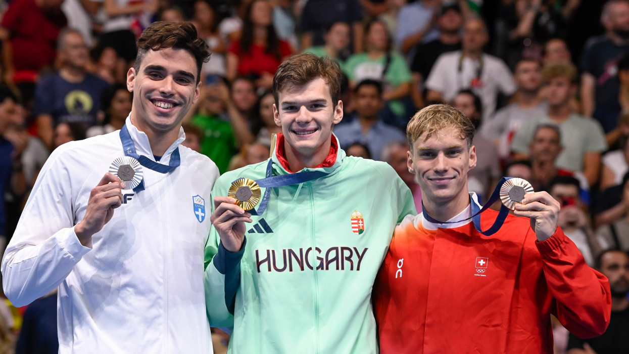 Nanterre, 2024. augusztus 1.Az aranyérmes Kós Hubert (k), az ezüstérmes görög Aposztolosz Hrisztu (b) és a bronzérmes svájci Roman Mityukov (j) a férfi 200  méteres hátúszás eredményhirdetésén a 2024-es párizsi nyári olimpián a Párizs melletti Nanterre-ben lévõ Paris La Défense Arénában 2024. augusztus 2-án.MTI/Kovács Tamás