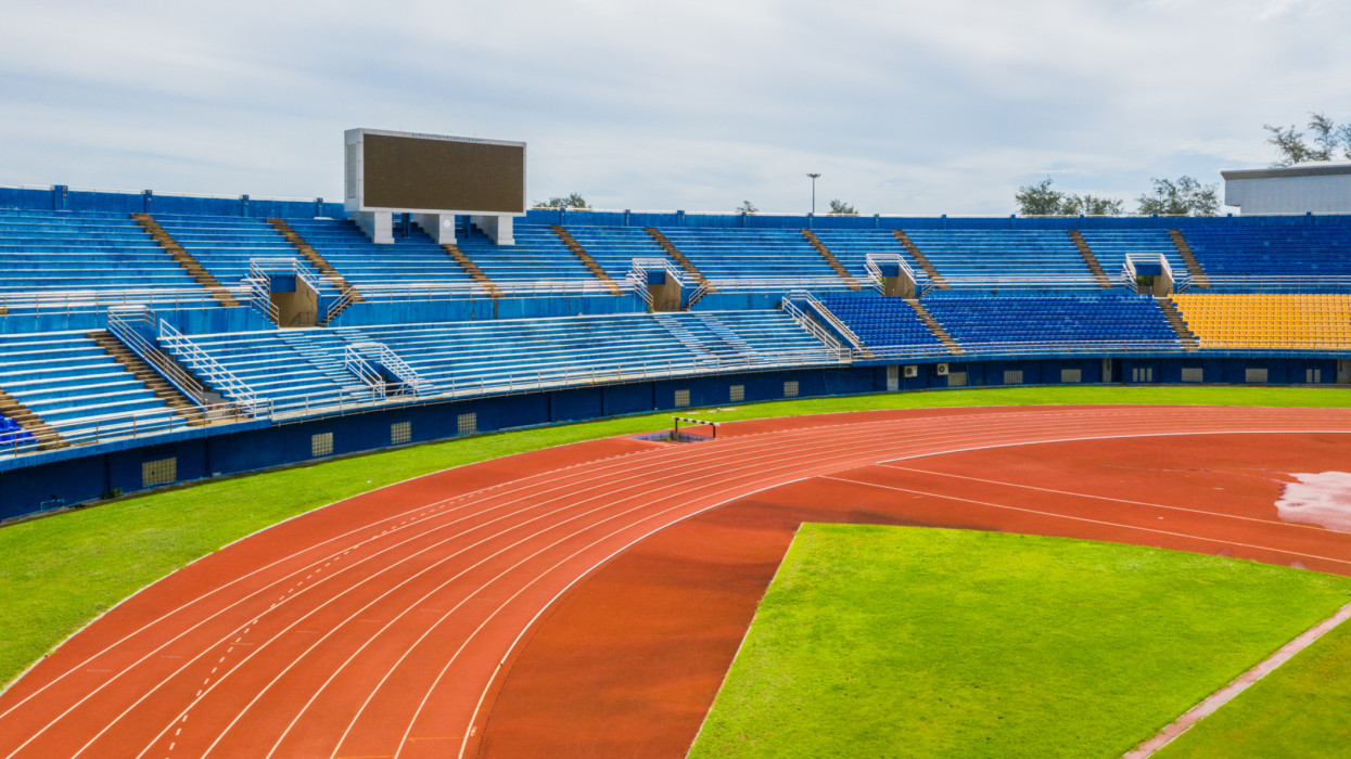 Aerial view of sports venue with soccer field and running track.