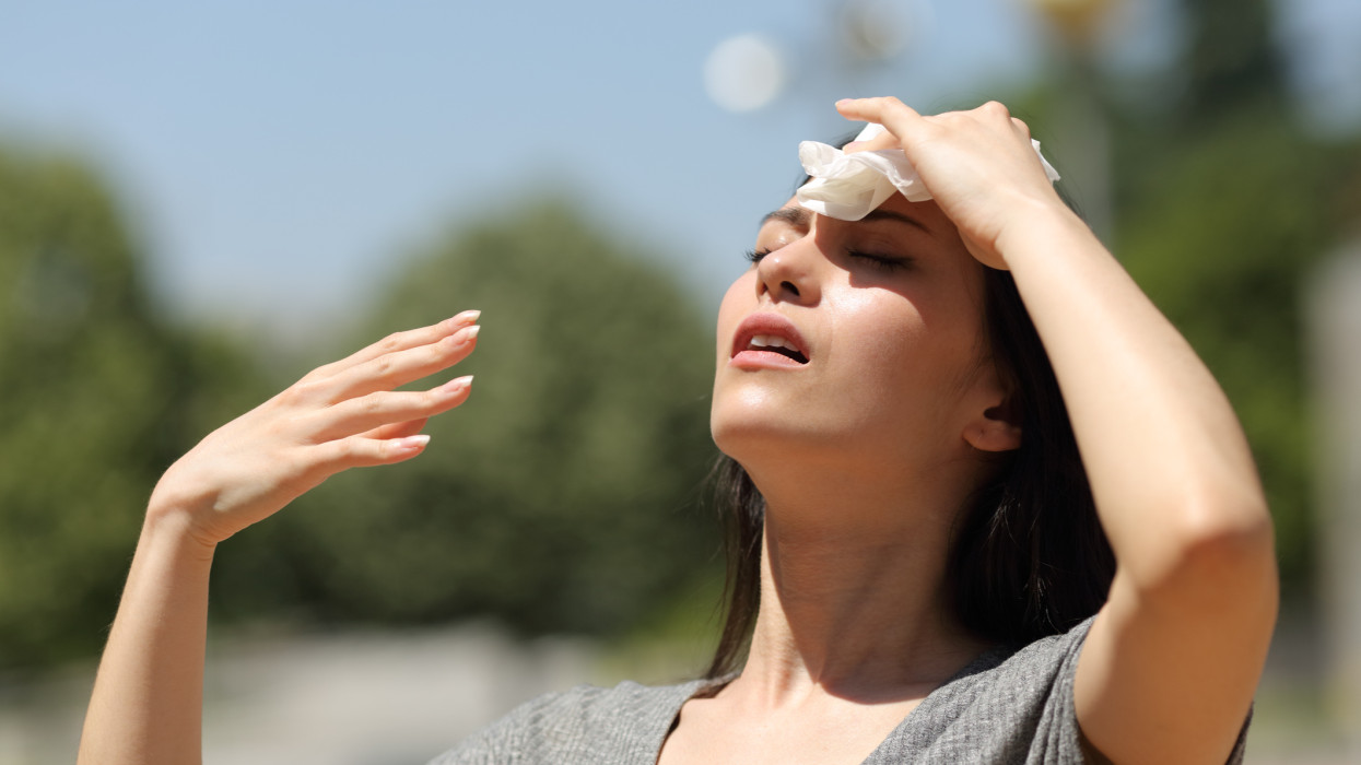 Asian woman drying sweat in a warm summer day