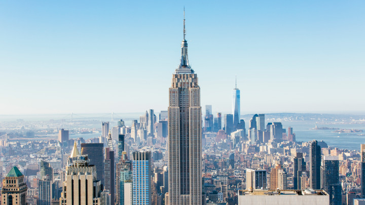 New York cityscape seen from above with clear blue sky.